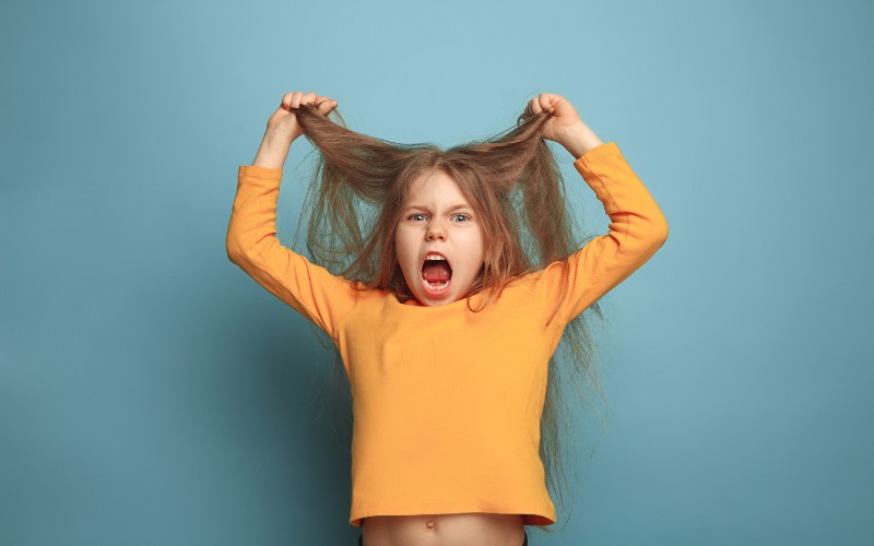 furious teen girl pulling out hair