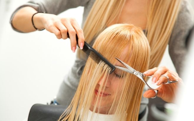 woman cutting hair at hair salon