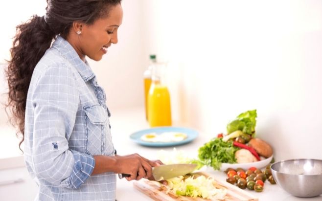 black woman in kitchen prepping healthy meal