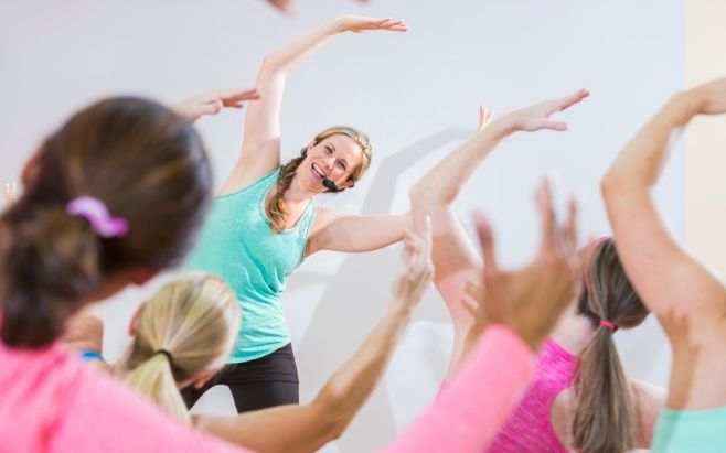 fitness instructor leading exercise class