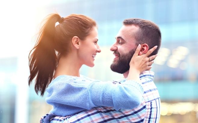 man and woman embracing each other feeling happy and smiling