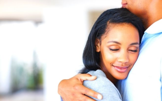Black woman hugging Black man