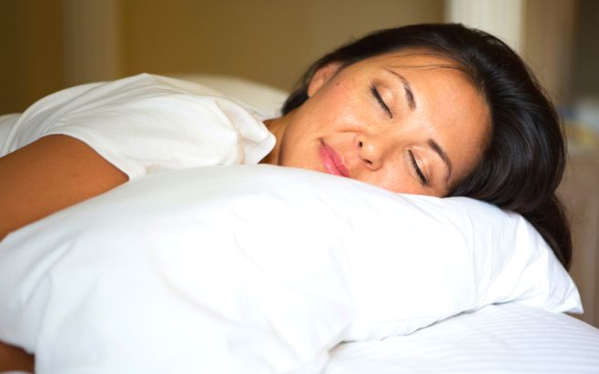 woman sleeping on pillow in bed