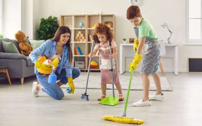 mom and kids cleaning up family room 
