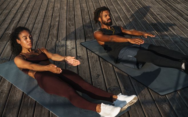 man and woman working out on mats outdoors
