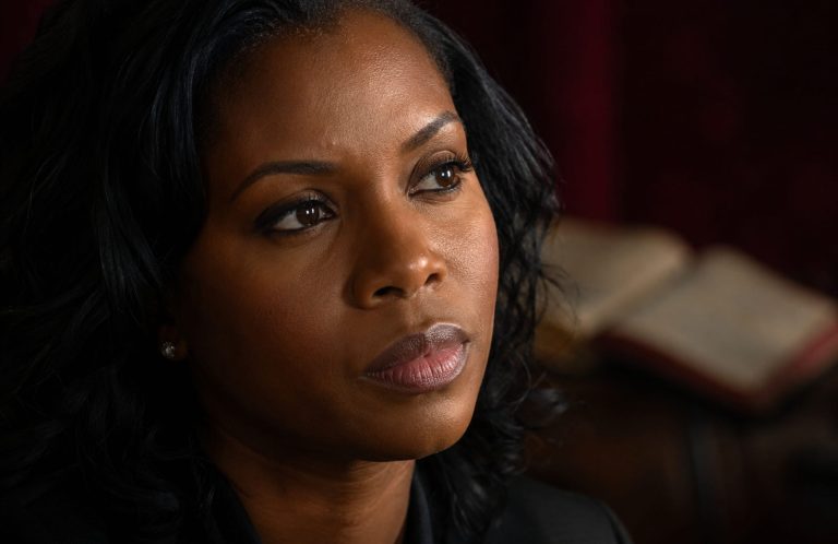Black woman with close up thinking next to a Bible in background